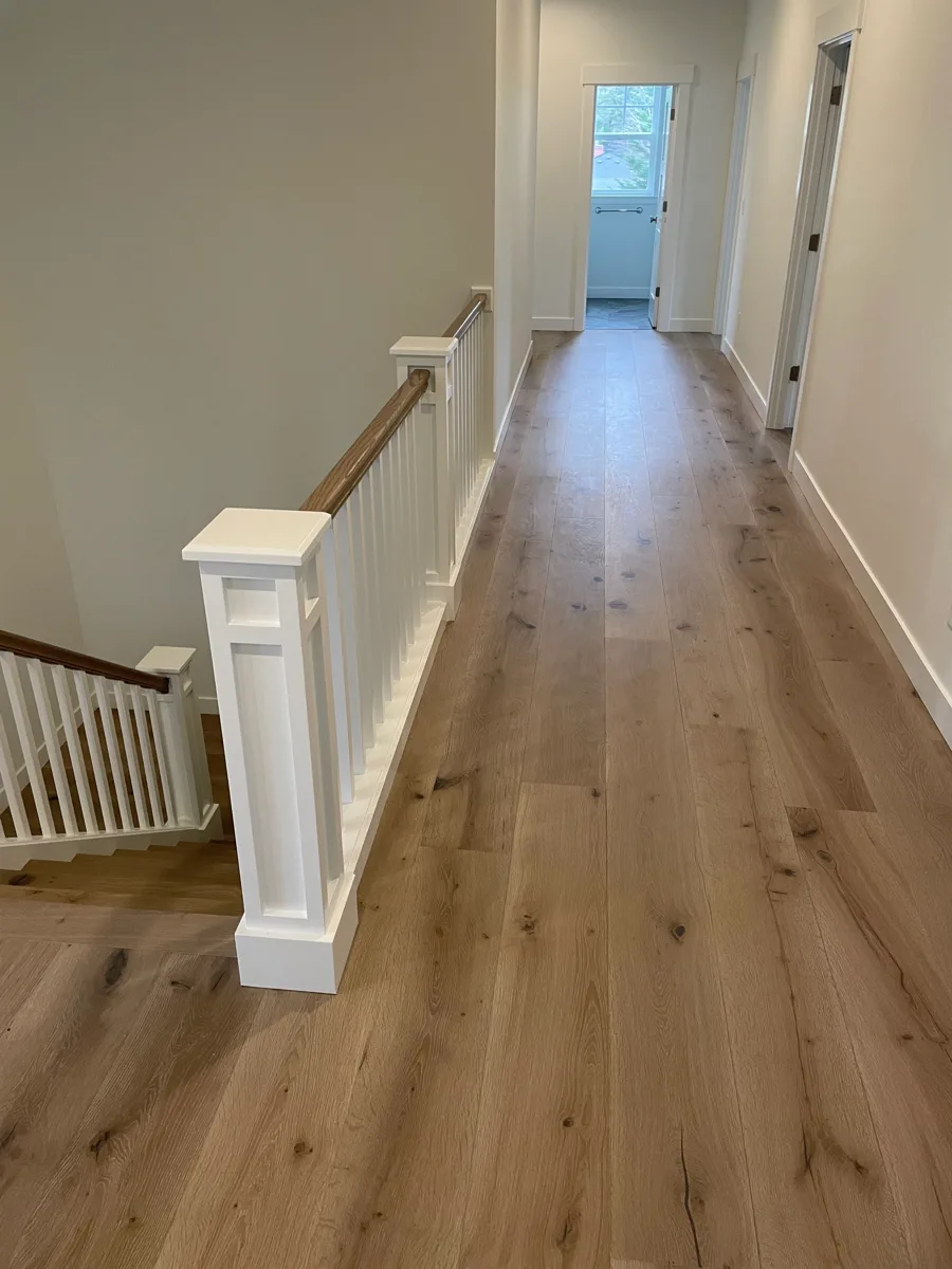 Light hardwood flooring in an upstairs landing and hallway