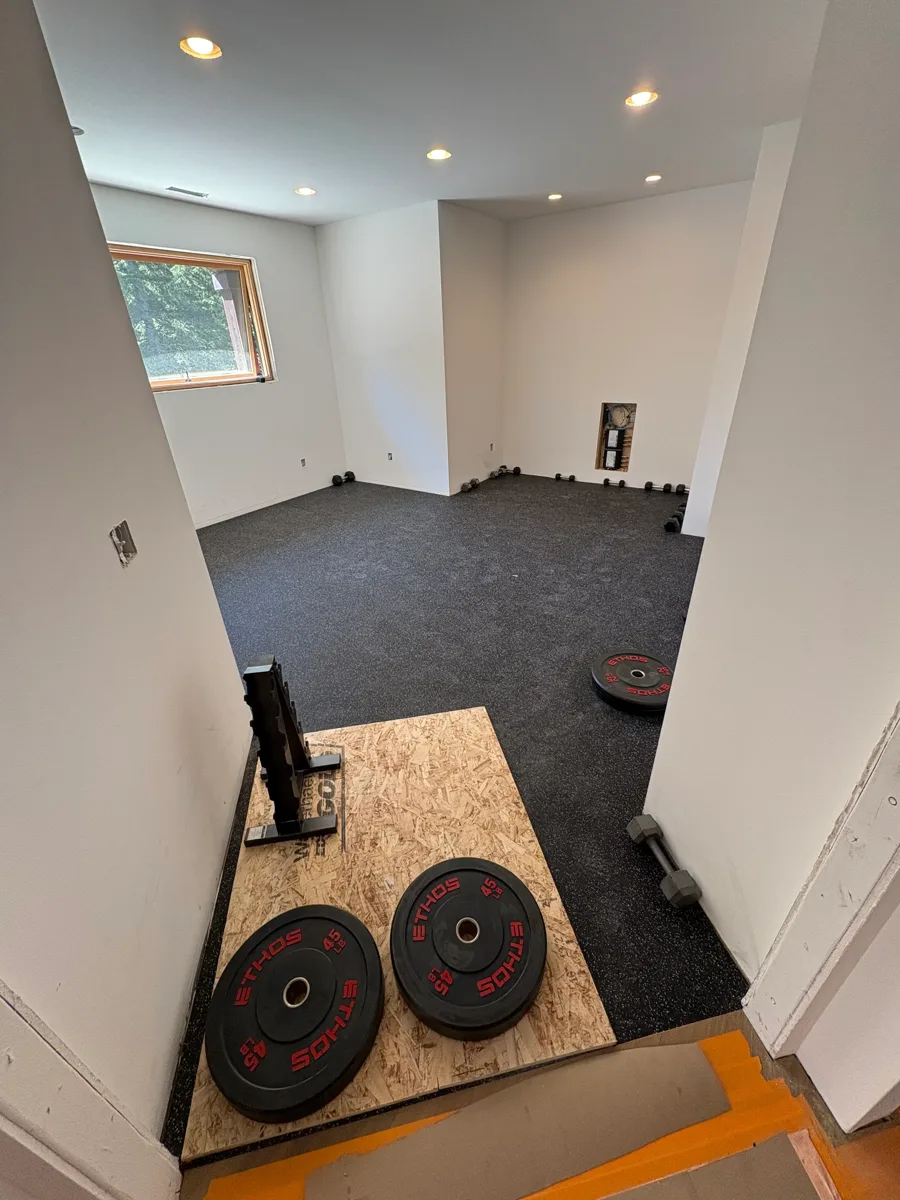 Carpeted basement home gym installed by Elite Northwest Flooring