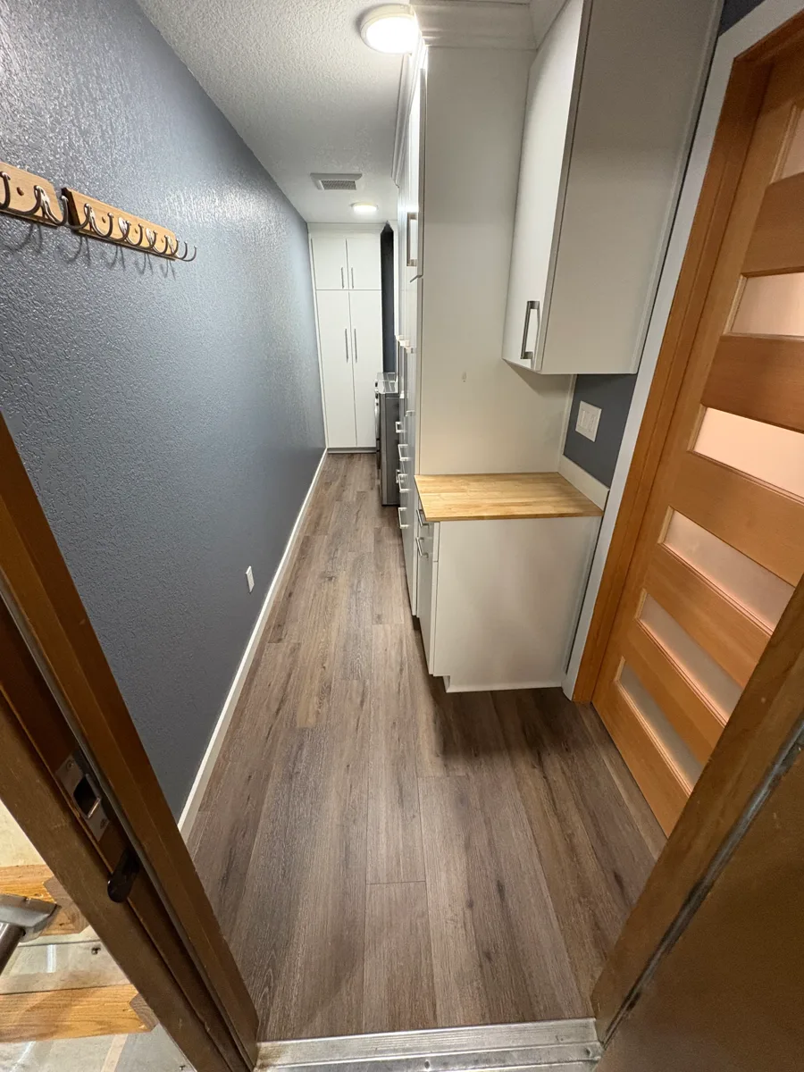 Luxury vinyl plank flooring in a hallway and mudroom
