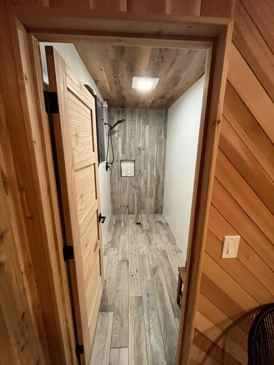 Wood-look luxury vinyl plank flooring in a cedar-lined hallway